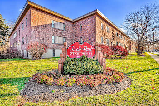 A brick building with a sign that says "Twilight Park" in front of it.