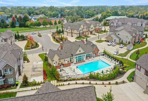 an aerial view of a pool and houses in a neighborhood at Encore at Manchester, Novi, 48377