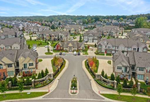 an aerial view of a neighborhood with houses and a street at Encore at Manchester, Novi