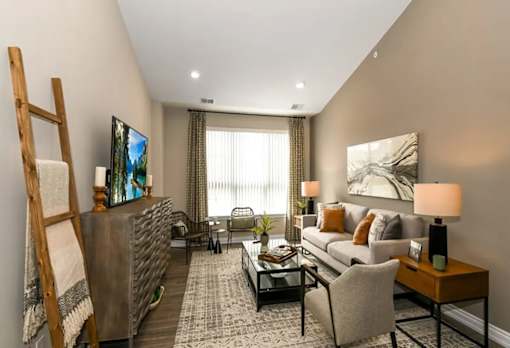 a living room with a couch and a table at Encore at Manchester, Novi, Michigan