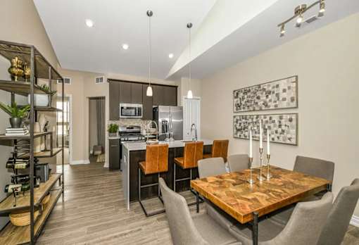 a kitchen and dining room with a table and chairs at Encore at Manchester, Novi, Michigan
