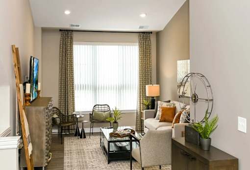 a living with a couch and a window at Encore at Manchester, Novi, Michigan