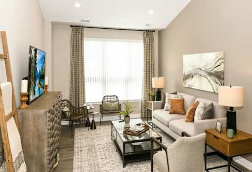 a living room with a couch at Encore at Manchester, Novi, MI