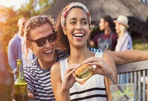 a group of young women eating hamburgers at a picnic at Encore at Manchester, Novi, 48377