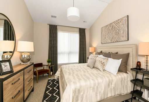 a bed and a window at Encore at Manchester, Novi, MI