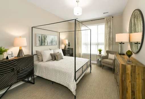 a bedroom with a bed and a large window at Encore at Manchester, Novi