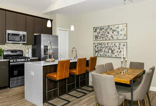 a kitchen and dining room with a table and chairs at Encore at Manchester, Novi, MI 48377