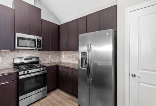 Modern Kitchen With Stainless Steel Appliances And Double Door Refrigerators at Encore Townhomes, Utica