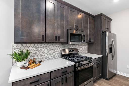 Large Island Kitchen With Custom Cabinetry at Encore at West Valley, White Lake, MI, 48386