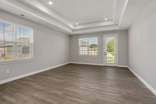Living room with light wood flooring and white walls at Encore at West Valley, Michigan