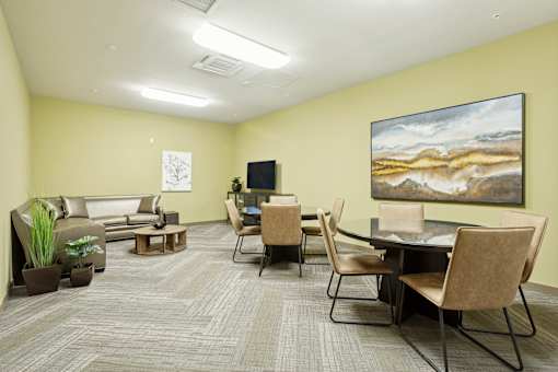 a living room with a table and chairs and a television