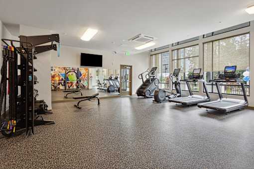 the gym with treadmills and weights at the belgard apartments