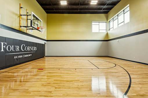 a basketball court in a gym with a wood floor