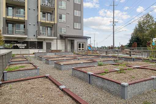 a community garden in front of an apartment building