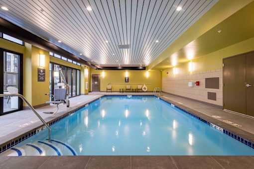 A large indoor swimming pool with a blue tiled edge.
