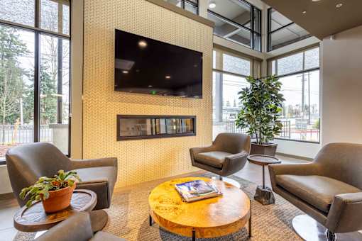 A living room with a flat screen TV mounted on the wall.
