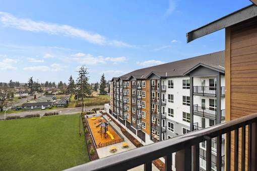 Exterior view of Kendrick Landing Apartments with playground in Lakewood, WA