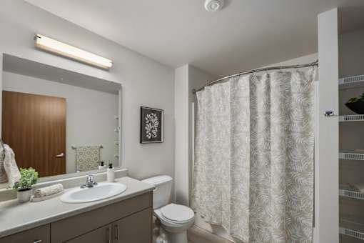 A Model bathroom at Kendrick Landing, Affordable Housing in Lakewood, WA with a spacious shower and Vanity