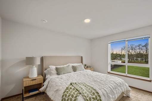 Primary bedroom inside a model apartment at Kendrick Landing Apartments