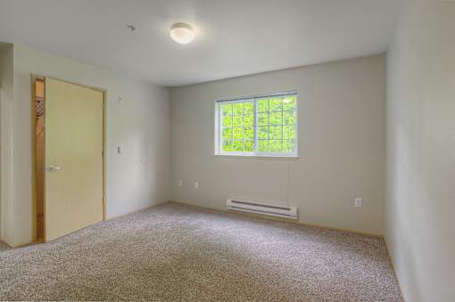 A room with a window and a door.