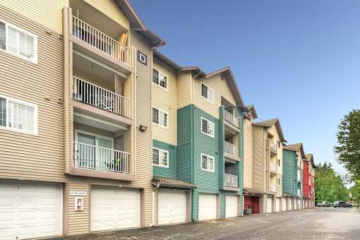 Apartment building with balconies and garages.