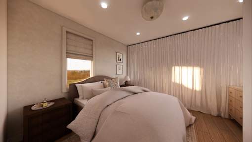 A bedroom with a large bed and a window with curtains.