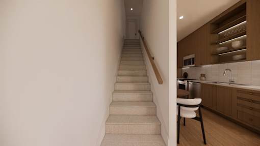 A staircase leads to a kitchen area with a white chair at the bottom.