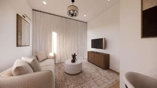 A living room with a couch, a television, and a plant.