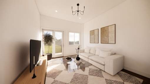 A modern living room with a white sofa and a television on a wooden stand.