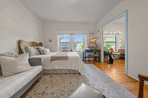 A bedroom with a large bed and a couch.