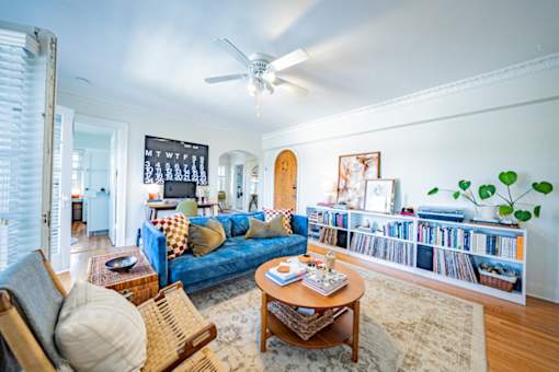 A living room with a blue couch and a coffee table.