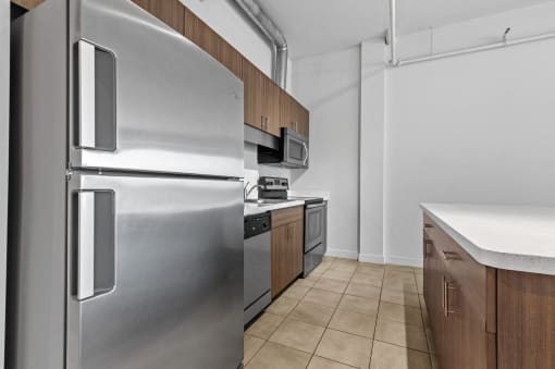 a kitchen with stainless steel appliances and wooden cabinets