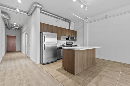 a kitchen with stainless steel appliances and a white counter top