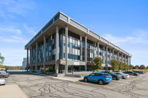 a large office building with cars parked outside