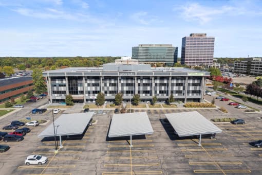 an aerial view of a parking lot in front of a building