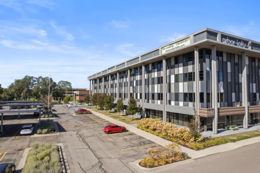 a large building with a parking lot in front of it