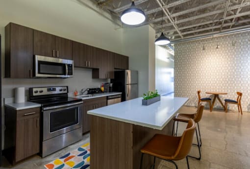 A kitchen with a white countertop and brown cabinets.