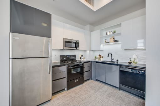 a kitchen with stainless steel appliances and white cabinets