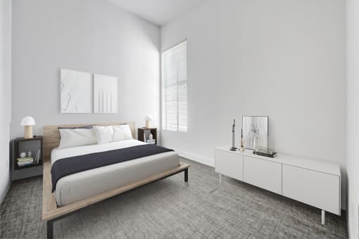 a bedroom with a bed and a dresser and a window