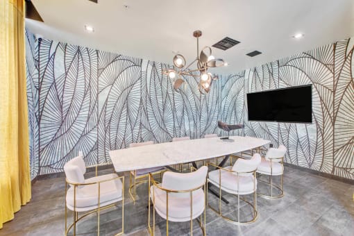 a dining room with a table and chairs and a wall mural