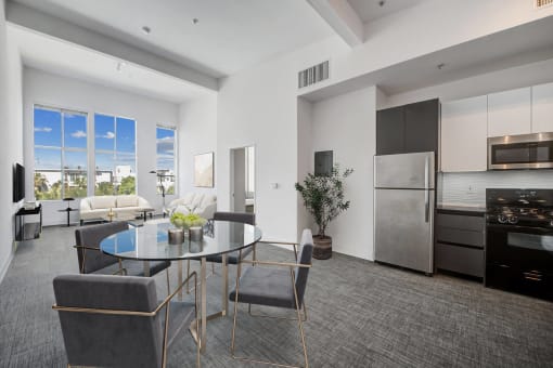 an open kitchen and living room with a table and chairs