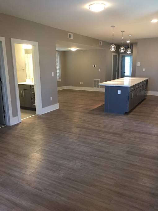 an empty kitchen and living room with a blue island