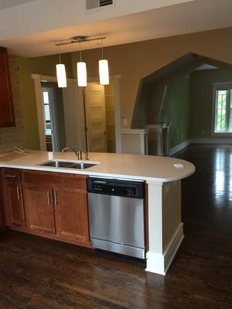an empty kitchen with a sink and a dishwasher