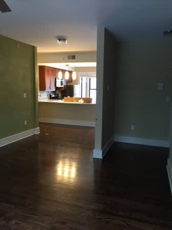 an empty living room with a hard wood floor