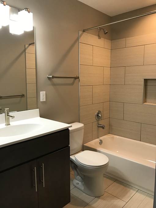 a bathroom with a toilet and a sink and a bath tub