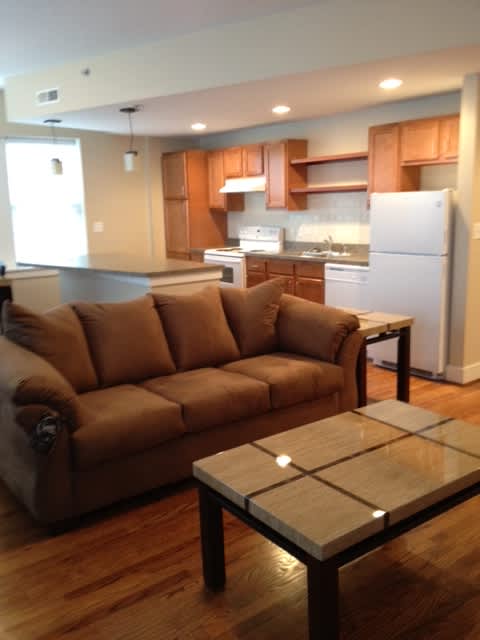 a living room with a couch and a kitchen