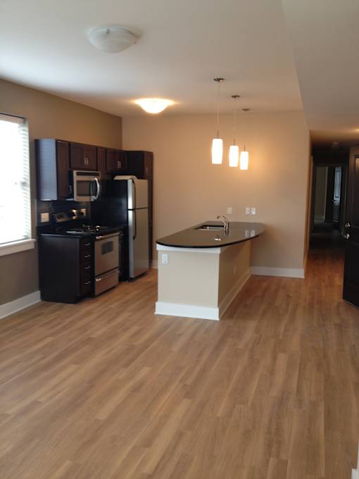 an empty kitchen with an island in the middle of it