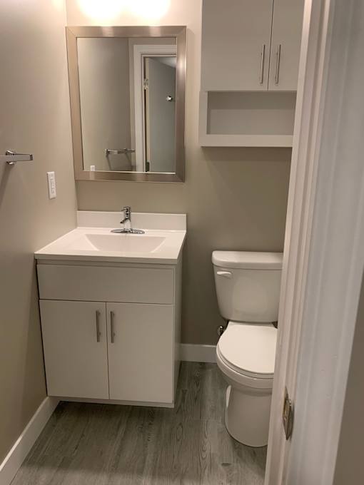 a small bathroom with a sink toilet and mirror