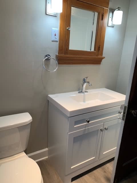 a bathroom with a toilet and a sink and a mirror