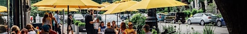 a group of people sitting under yellow umbrellas
